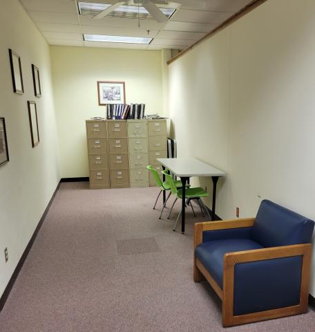 This room has a table and two chairs and an electrical outlet that can be used